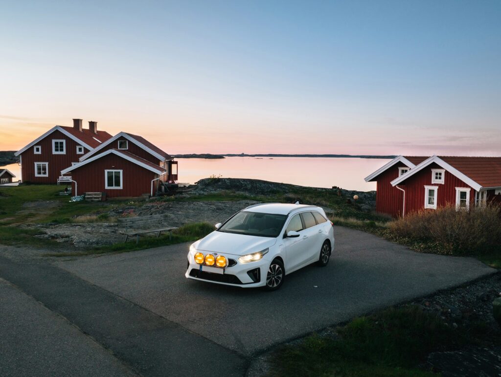 White Volvo estate with Luxtar Stellar driving lights by red cabins