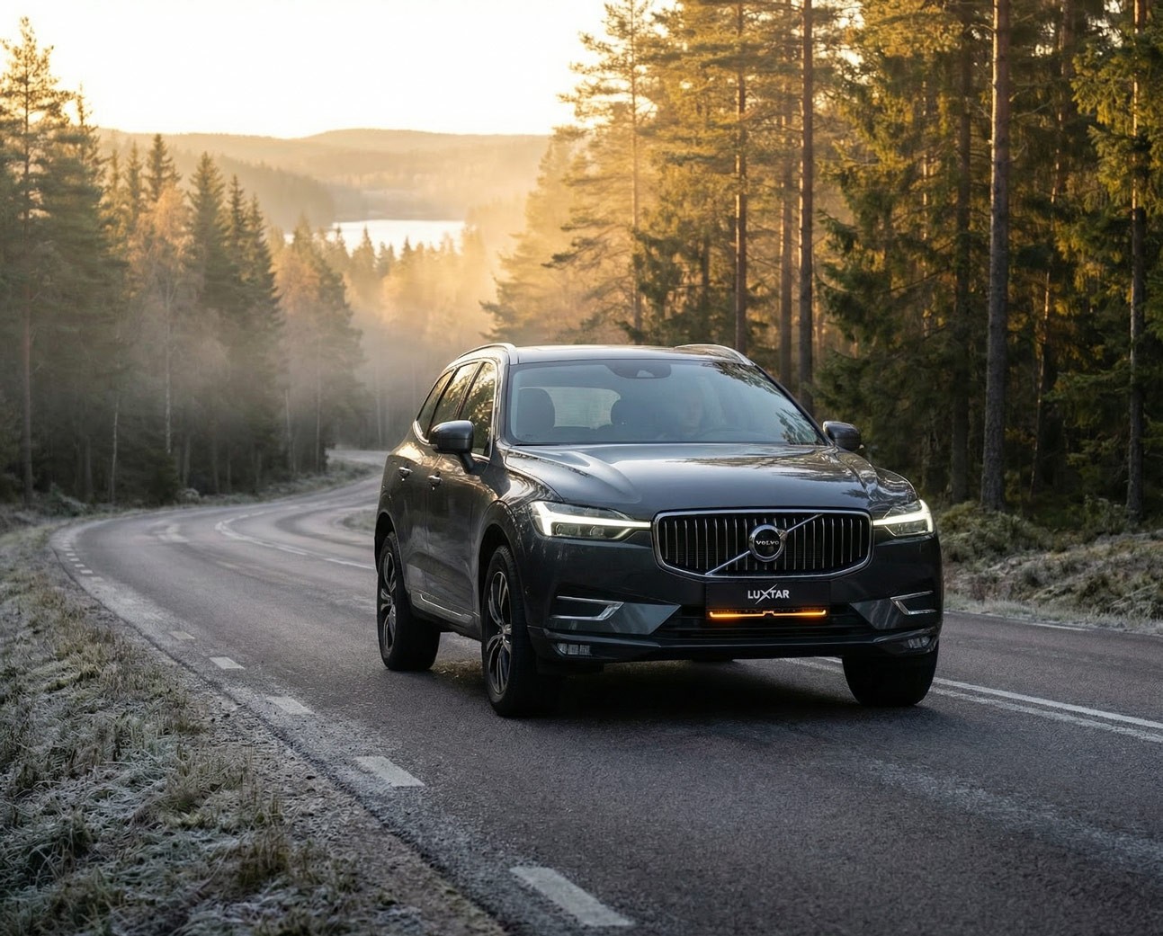 Dark Volvo XC60 with Luxtar Twilight on a forest road